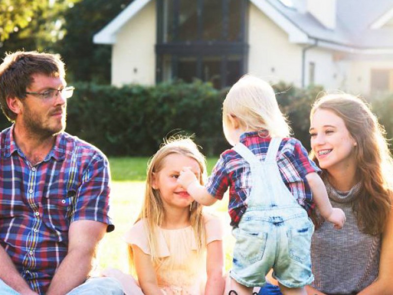 Famille heureuse dans son jardin après un rachat de crédits